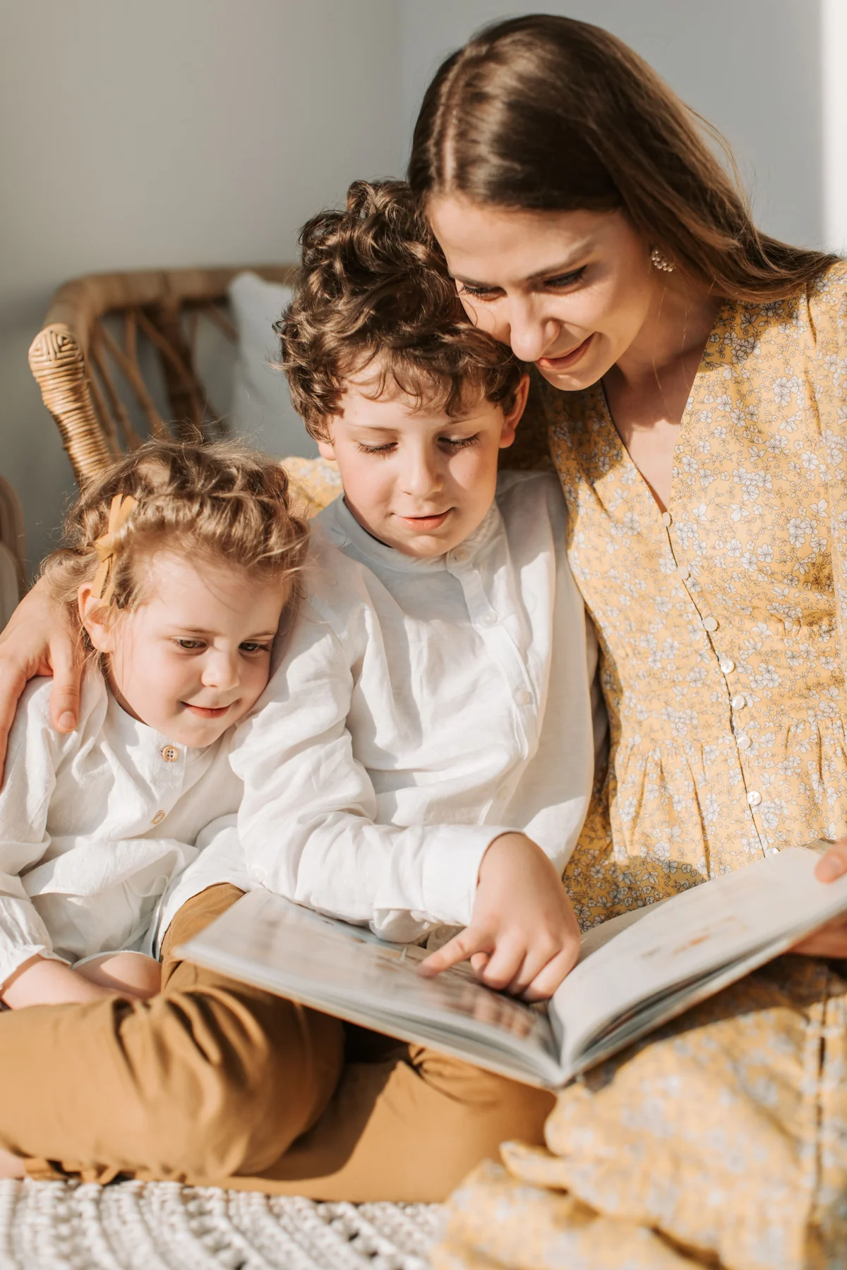 A parent and two children spending time together at home.